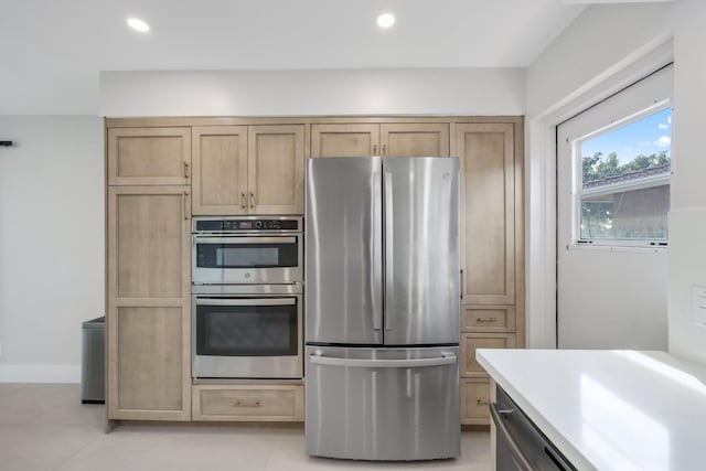 kitchen featuring appliances with stainless steel finishes and light tile patterned floors