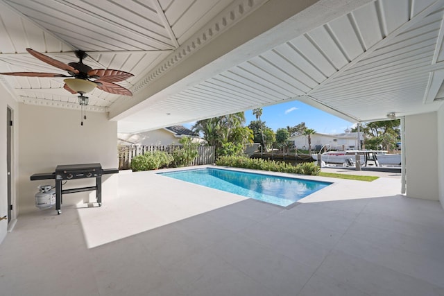 view of pool with ceiling fan, grilling area, and a patio