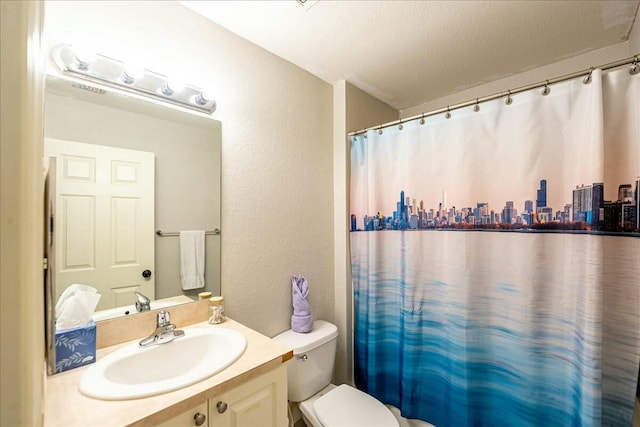 bathroom featuring vanity, curtained shower, a textured ceiling, and toilet