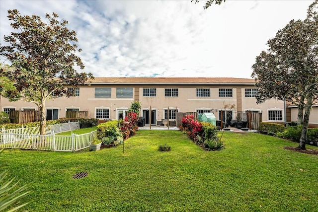 rear view of property with a lawn