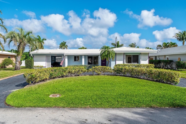 single story home with a front yard and a carport