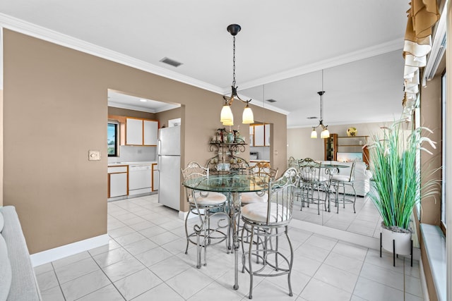 dining space featuring crown molding and light tile patterned flooring