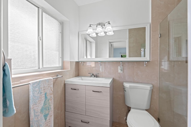 bathroom with vanity, tile walls, and toilet