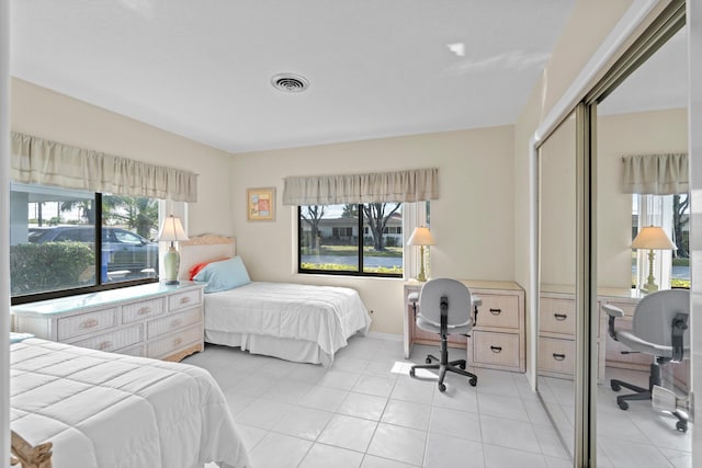 bedroom featuring light tile patterned floors and a closet