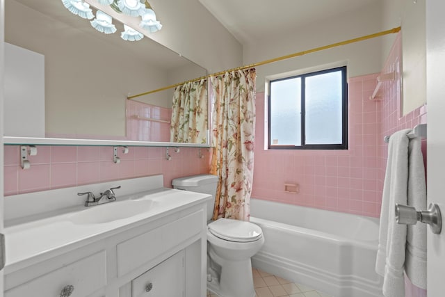 full bathroom with shower / tub combo with curtain, tile walls, vanity, toilet, and tile patterned floors