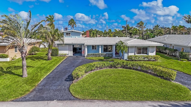 view of front of house with a front lawn and a carport