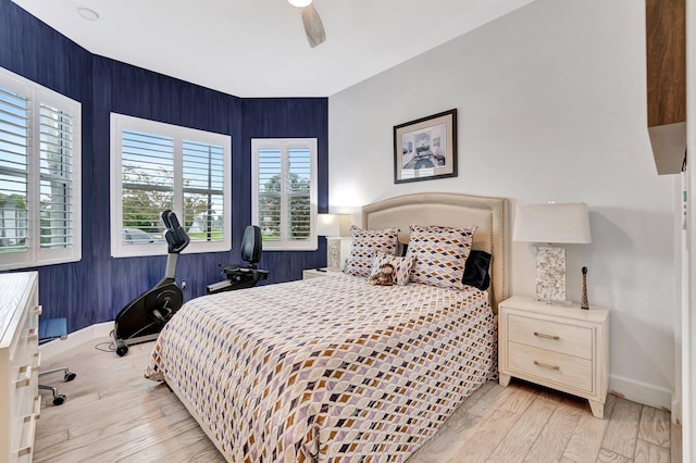 bedroom with light wood-style flooring, baseboards, and a ceiling fan