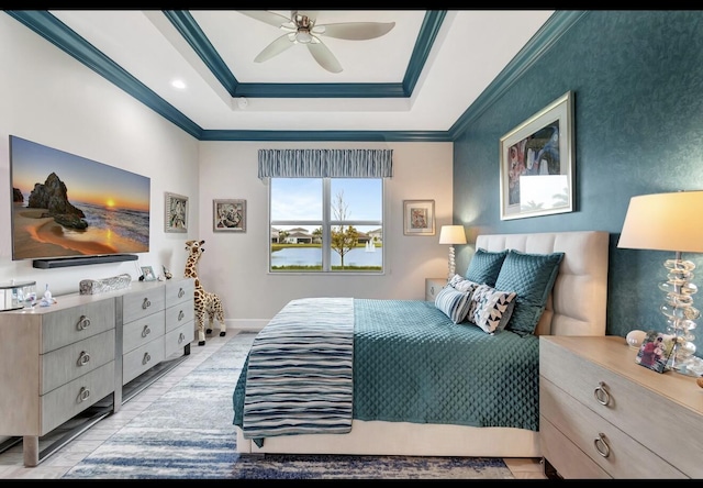 bedroom with ceiling fan, ornamental molding, and a raised ceiling