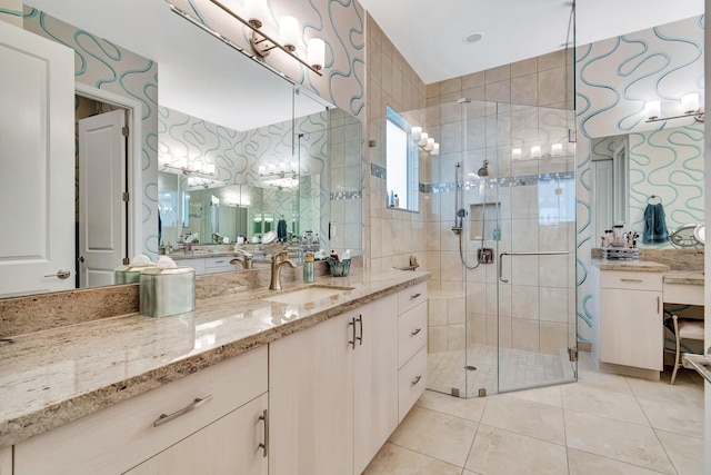 bathroom with vanity, a shower with shower door, and tile patterned floors