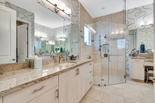 bathroom featuring tile patterned floors, vanity, and a shower with door