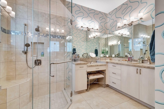 bathroom featuring a shower with door, vanity, and tile patterned floors