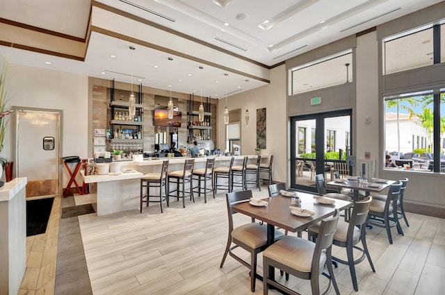 dining space with recessed lighting, french doors, and a high ceiling