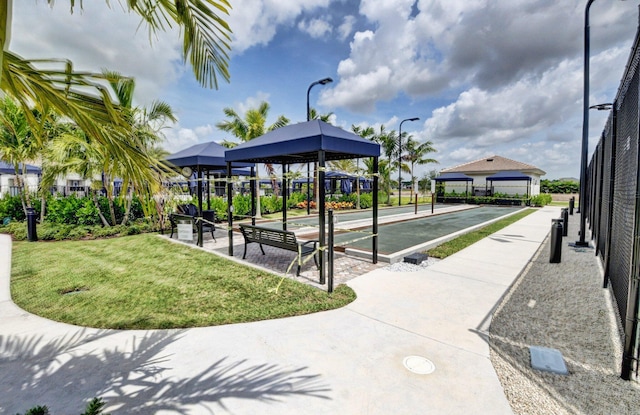 view of community featuring a yard and fence