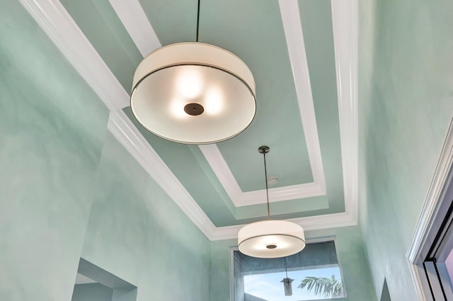 interior details featuring crown molding and a raised ceiling