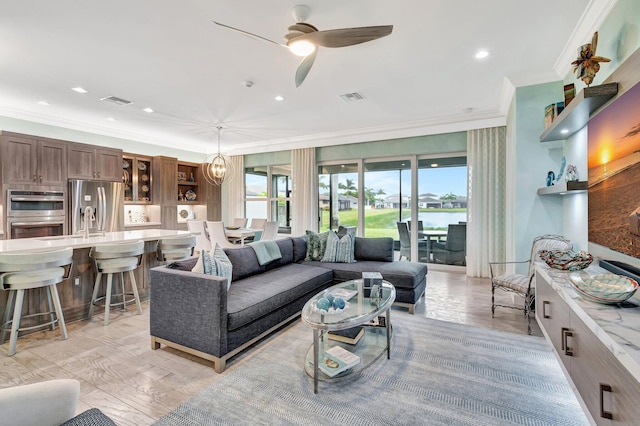 living room with ornamental molding and ceiling fan with notable chandelier