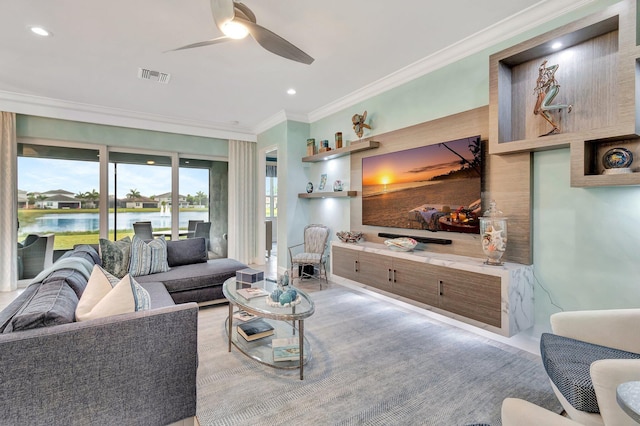 living room featuring ornamental molding, a water view, and ceiling fan