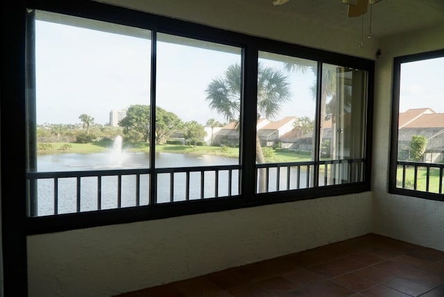 unfurnished sunroom with a water view