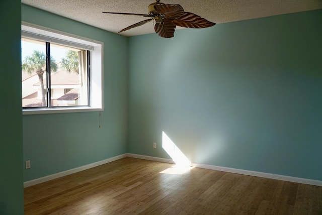 unfurnished room featuring hardwood / wood-style floors, a textured ceiling, and ceiling fan