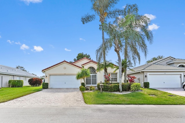 view of front of house with a garage and a front yard