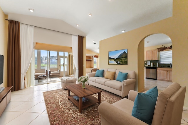 living room with lofted ceiling and light tile patterned floors