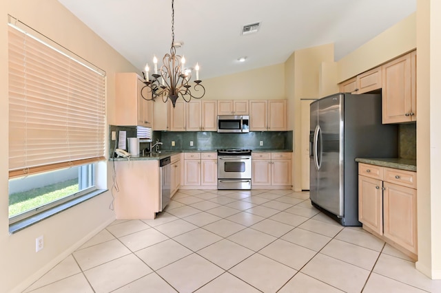 kitchen with decorative light fixtures, tasteful backsplash, lofted ceiling, light tile patterned floors, and stainless steel appliances