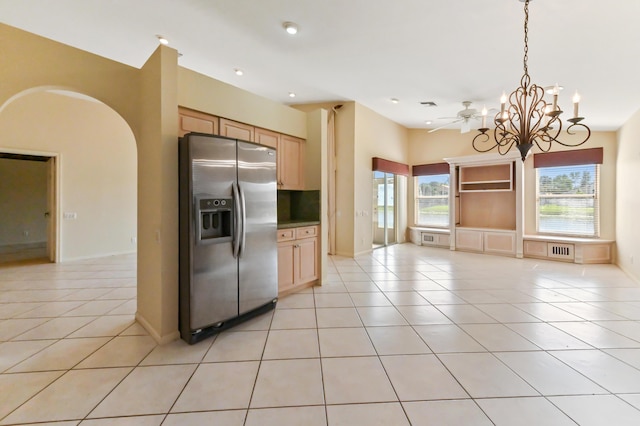 kitchen with light tile patterned flooring, pendant lighting, stainless steel fridge, and light brown cabinetry