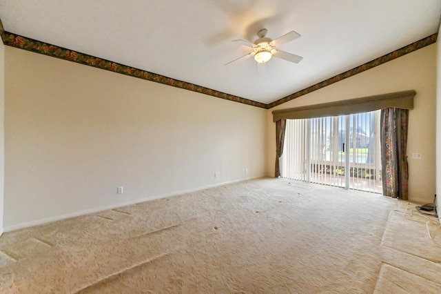 empty room featuring vaulted ceiling, ceiling fan, and carpet flooring