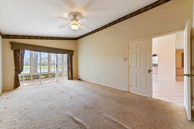 empty room featuring ceiling fan and light colored carpet