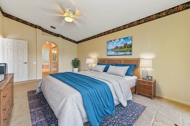 carpeted bedroom with ceiling fan and ensuite bath