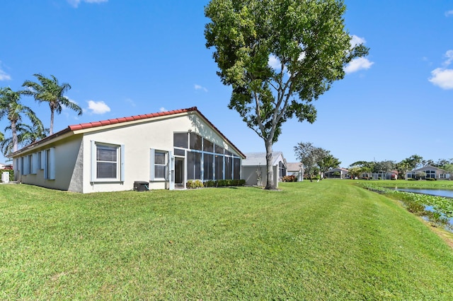 exterior space with a yard and a water view