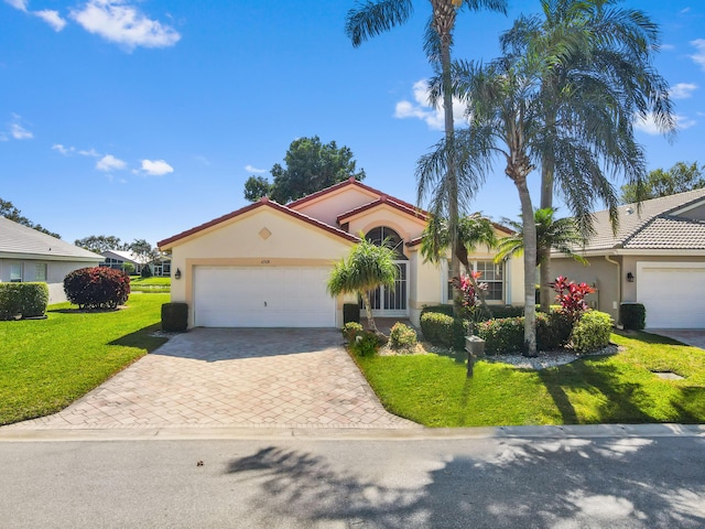 view of front of property with a garage and a front lawn