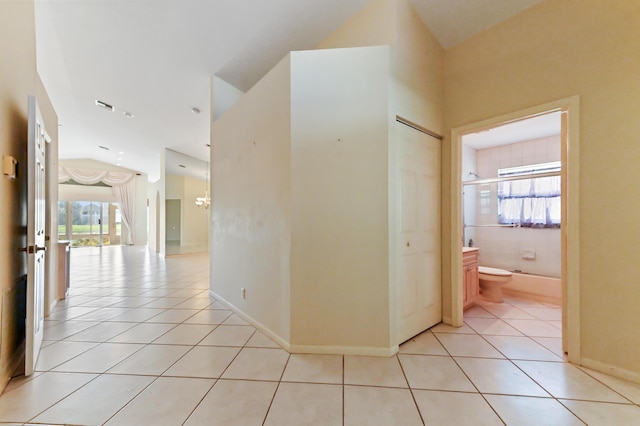 corridor featuring light tile patterned floors and a healthy amount of sunlight