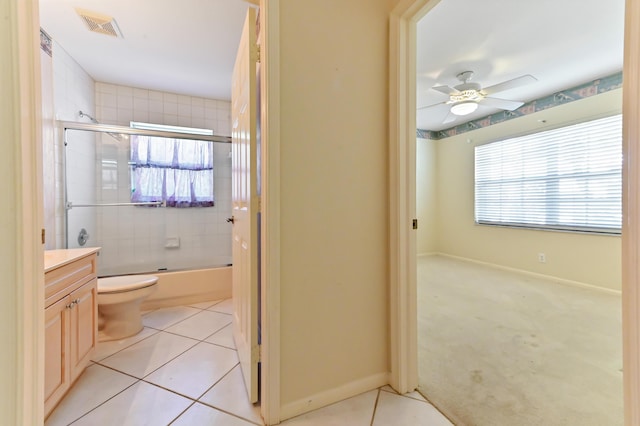 full bathroom with toilet, tile patterned floors, shower / bath combination with glass door, and plenty of natural light