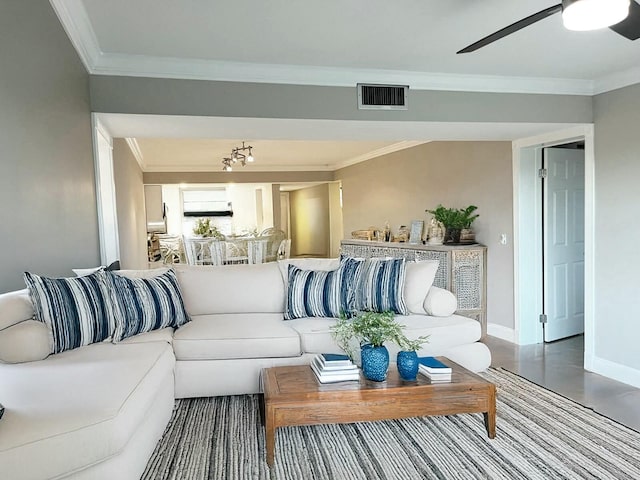 living room with hardwood / wood-style flooring, crown molding, and ceiling fan