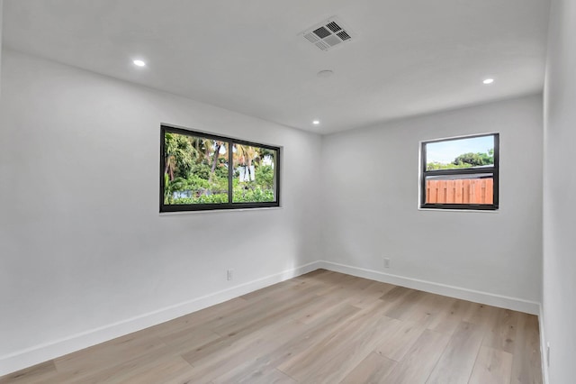 unfurnished room with plenty of natural light and light hardwood / wood-style flooring