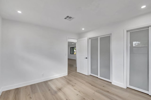 unfurnished bedroom with light wood-type flooring