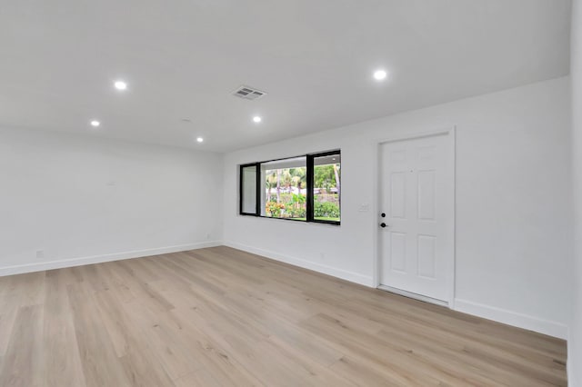 spare room featuring light hardwood / wood-style floors