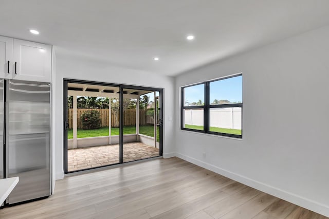 unfurnished room with light hardwood / wood-style flooring