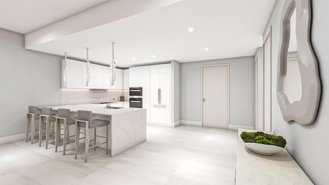 kitchen with tasteful backsplash, white cabinets, sink, kitchen peninsula, and a breakfast bar