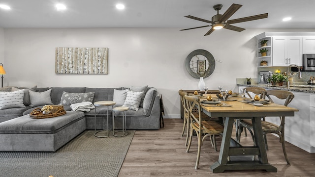 living room featuring hardwood / wood-style floors and ceiling fan