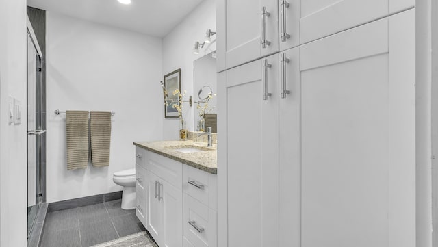 bathroom with toilet, vanity, an enclosed shower, and tile patterned flooring