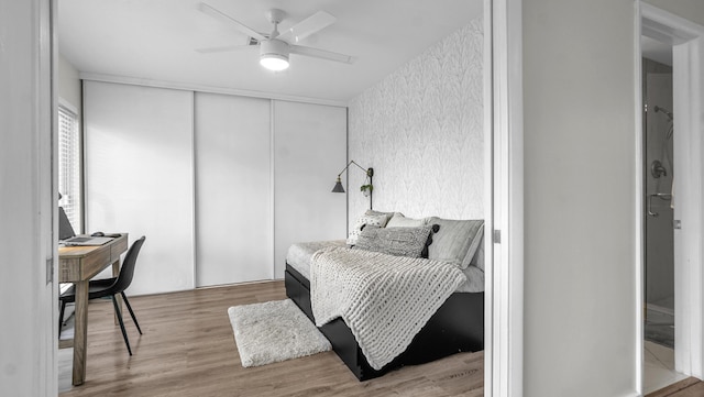 bedroom featuring hardwood / wood-style floors, a closet, and ceiling fan