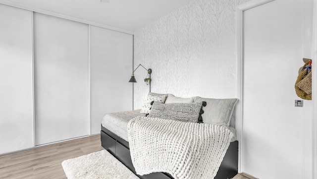 bedroom with a closet and light wood-type flooring