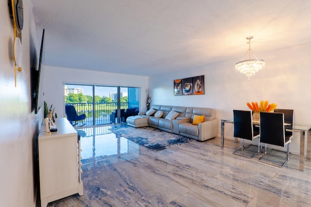 living room with a chandelier and a textured ceiling