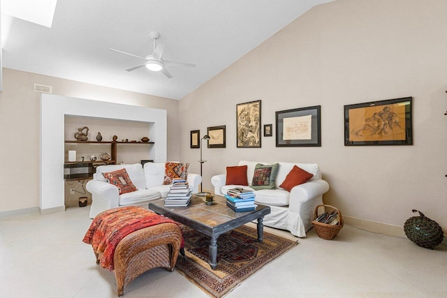 living room featuring built in shelves, vaulted ceiling with skylight, ceiling fan, and baseboards