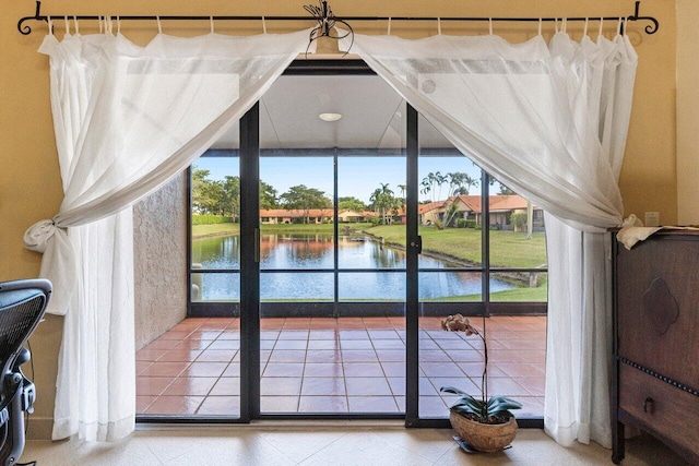 doorway featuring tile patterned flooring and a water view