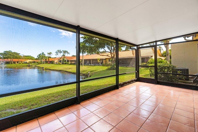 unfurnished sunroom with a water view