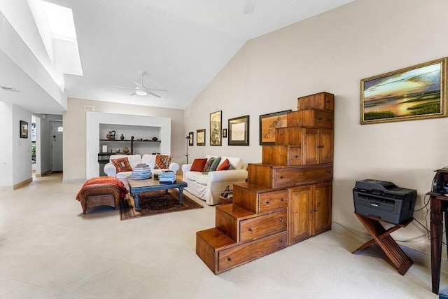 living room featuring a skylight, ceiling fan, high vaulted ceiling, and baseboards