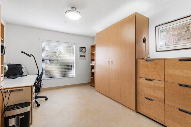 office area with a textured ceiling and baseboards