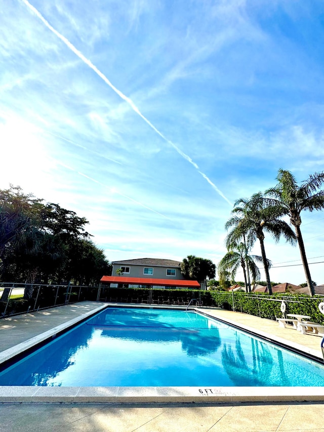 community pool featuring a patio area and fence